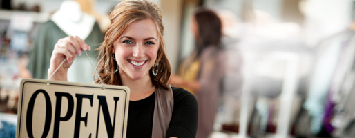 woman holding open sign